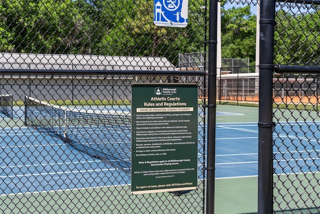 view of tennis court featuring fence