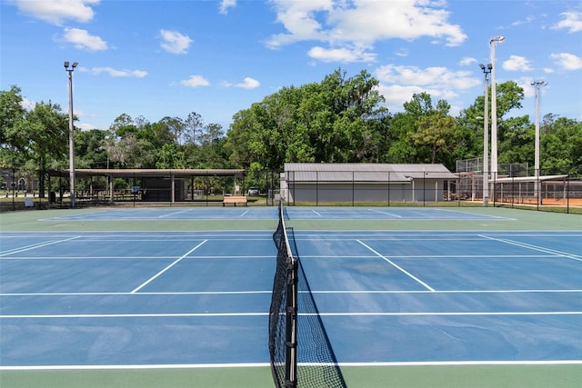 view of sport court featuring fence