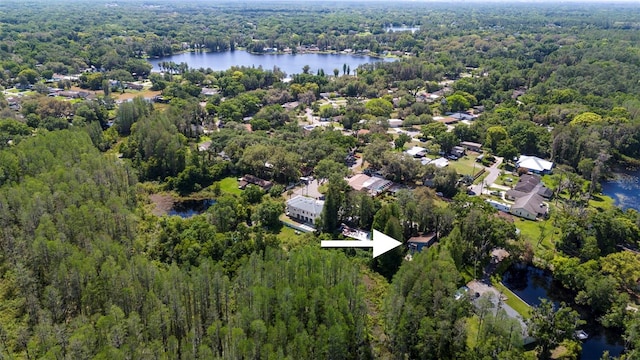 aerial view with a forest view and a water view