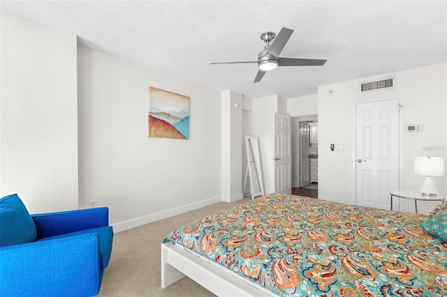 carpeted bedroom with baseboards, visible vents, a textured ceiling, and a ceiling fan