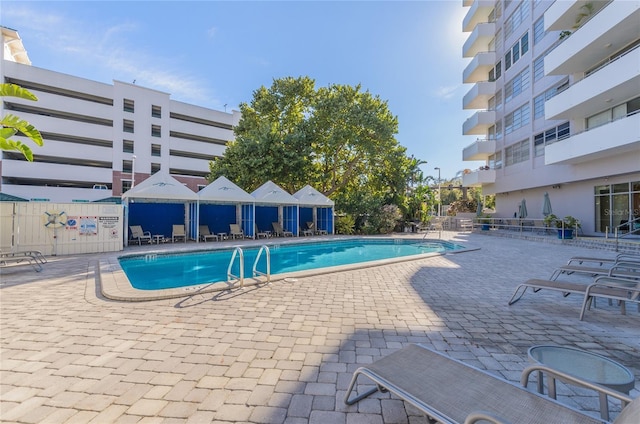 community pool with a patio area