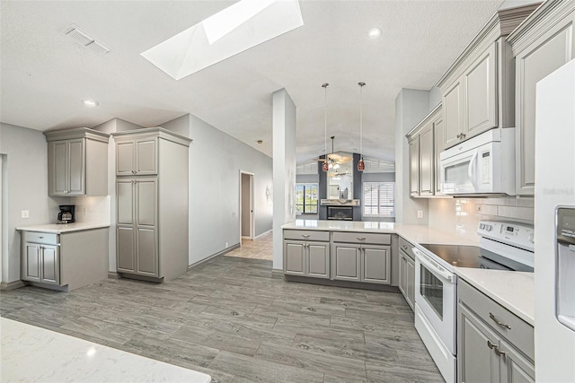 kitchen featuring white appliances, a ceiling fan, light countertops, and gray cabinetry