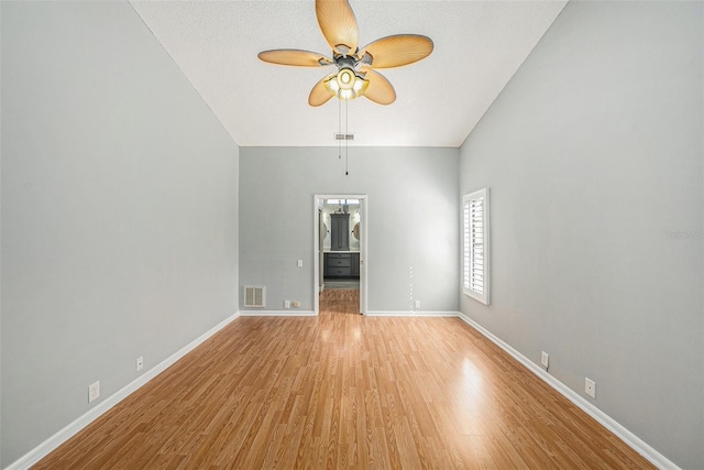 spare room featuring visible vents, a ceiling fan, light wood-type flooring, and baseboards