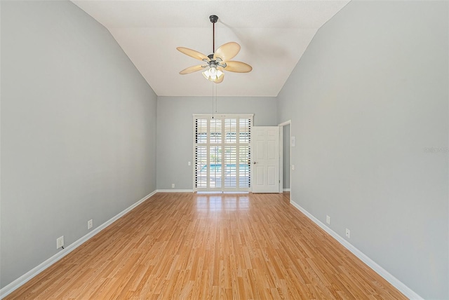 unfurnished room with lofted ceiling, baseboards, light wood-type flooring, and a ceiling fan