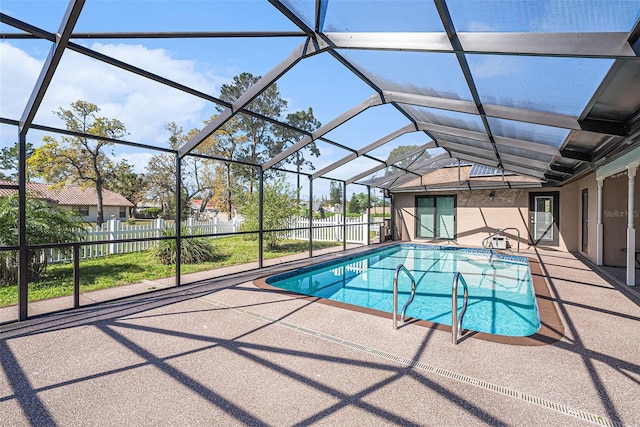 view of pool featuring a patio area, glass enclosure, a fenced in pool, and fence