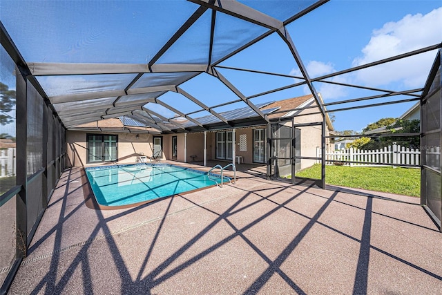 view of swimming pool with a lanai, a fenced in pool, a patio, and fence