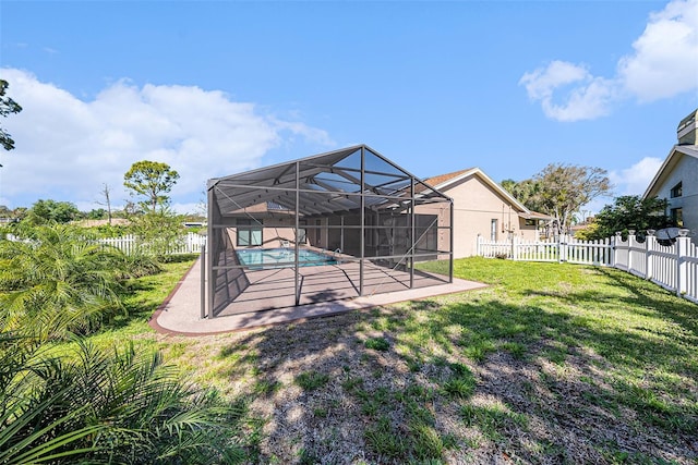 view of yard with a patio area, a fenced in pool, a lanai, and a fenced backyard