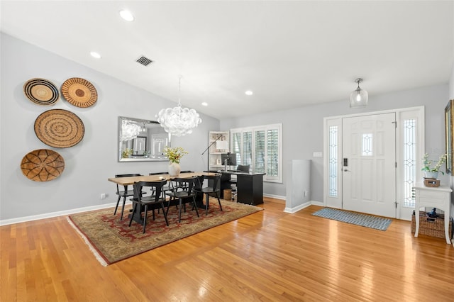 dining area with light wood finished floors, visible vents, recessed lighting, and vaulted ceiling