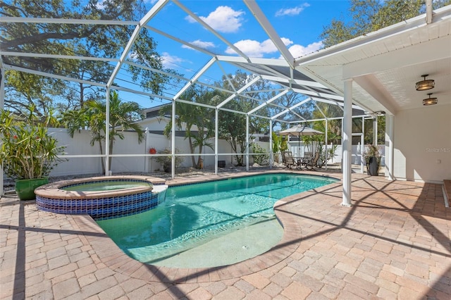 view of pool featuring glass enclosure, a patio, a pool with connected hot tub, and a fenced backyard