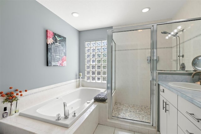 bathroom featuring a bath, recessed lighting, a stall shower, and vanity