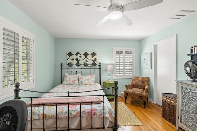 bedroom featuring multiple windows, wood finished floors, and visible vents