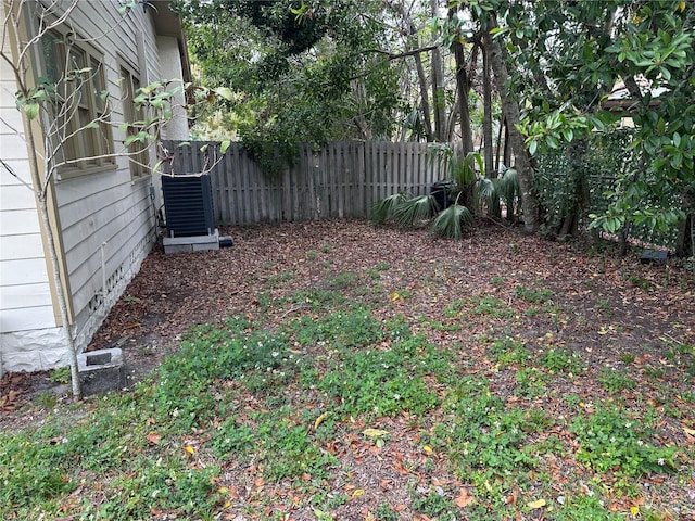 view of yard with cooling unit and fence