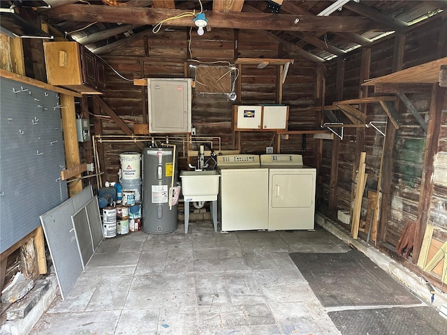 garage with washer and dryer, electric water heater, and a sink