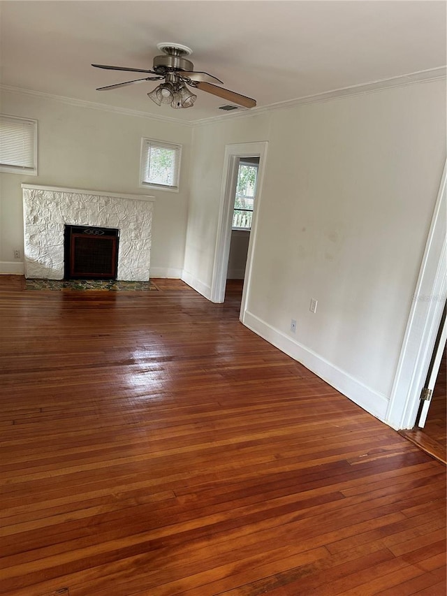 unfurnished living room featuring ornamental molding, a fireplace, and hardwood / wood-style flooring