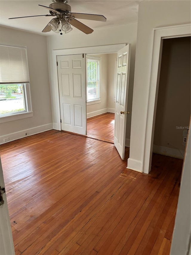 unfurnished bedroom with baseboards and hardwood / wood-style floors