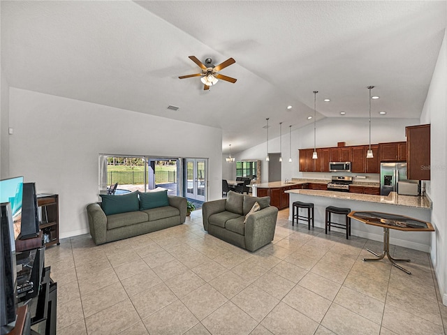 living room featuring visible vents, high vaulted ceiling, a ceiling fan, light tile patterned flooring, and baseboards