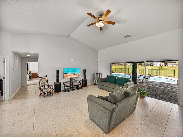 living room with light tile patterned floors, visible vents, high vaulted ceiling, and a ceiling fan