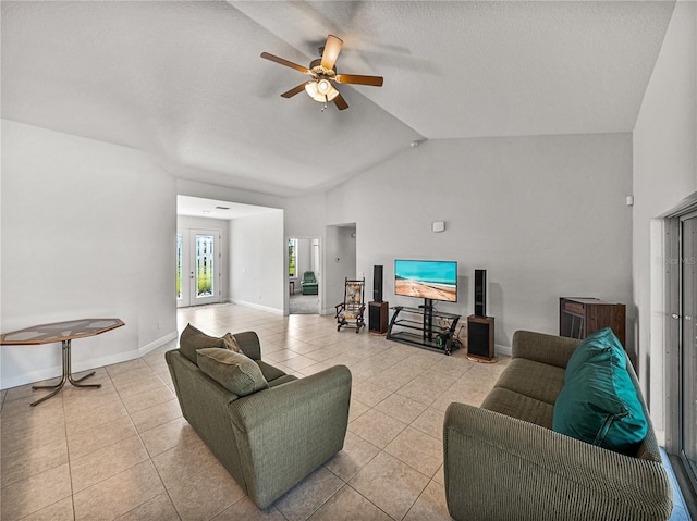 tiled living room featuring baseboards, ceiling fan, and vaulted ceiling