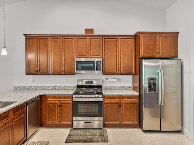 kitchen featuring light stone counters, light tile patterned floors, and stainless steel appliances