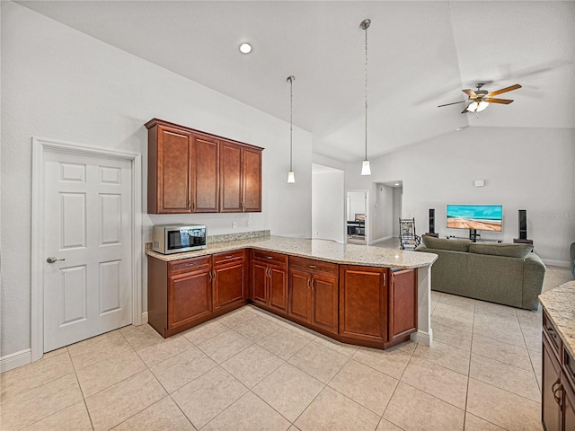 kitchen with stainless steel microwave, light tile patterned floors, light stone countertops, and ceiling fan