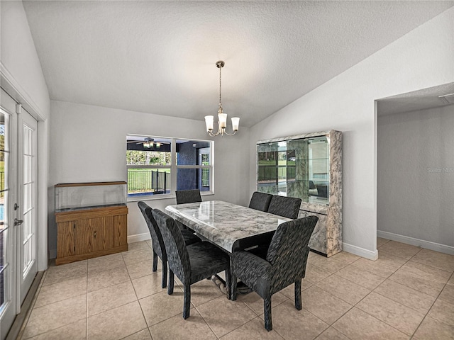 dining room featuring light tile patterned floors, baseboards, lofted ceiling, and a notable chandelier