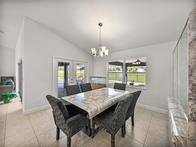 dining room with light tile patterned floors, french doors, an inviting chandelier, and vaulted ceiling