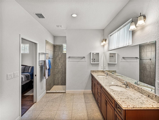 full bathroom with baseboards, walk in shower, and a sink