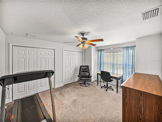 home office featuring visible vents, baseboards, carpet, and a ceiling fan