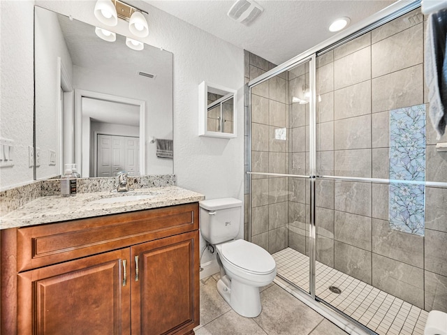 bathroom featuring tile patterned flooring, visible vents, a stall shower, and toilet