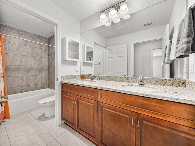 full bathroom featuring tile patterned flooring, visible vents, a textured ceiling, and a sink