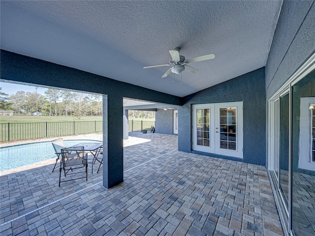 view of patio featuring a fenced in pool, a ceiling fan, fence, and french doors