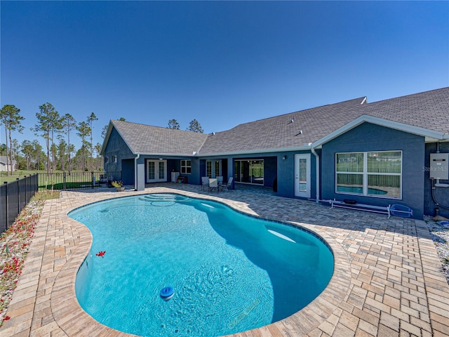 view of swimming pool with french doors, a patio, a fenced in pool, and fence