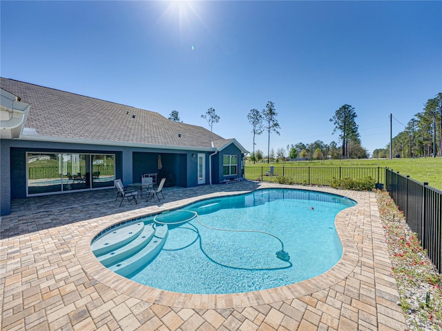 view of swimming pool featuring a patio area, a fenced in pool, a fenced backyard, and a lawn