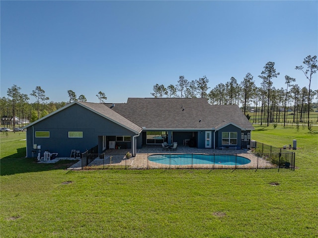 view of swimming pool with a yard, a fenced in pool, a patio, and fence