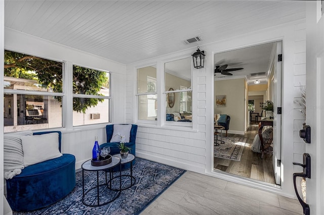 sunroom / solarium featuring visible vents and a ceiling fan