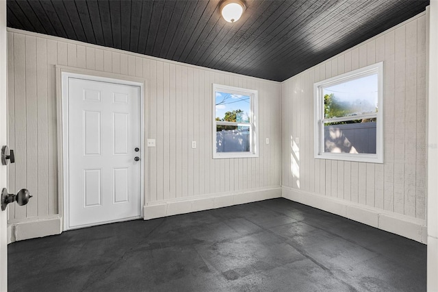 interior space featuring wood ceiling and baseboards