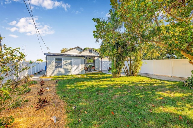 view of yard featuring an outbuilding and a fenced backyard