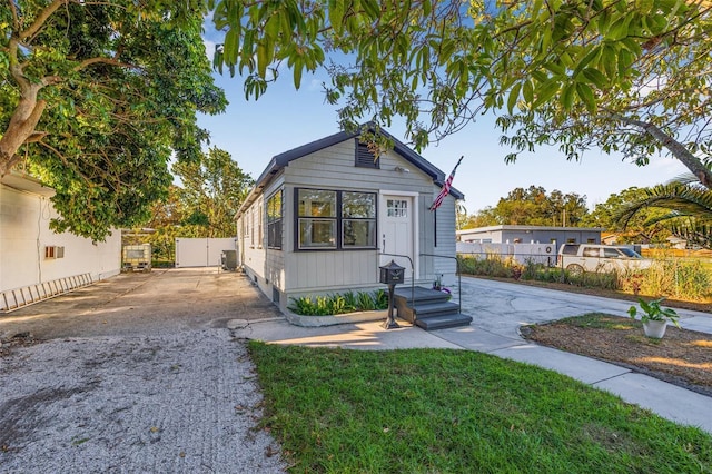 view of front of home with a front lawn and fence