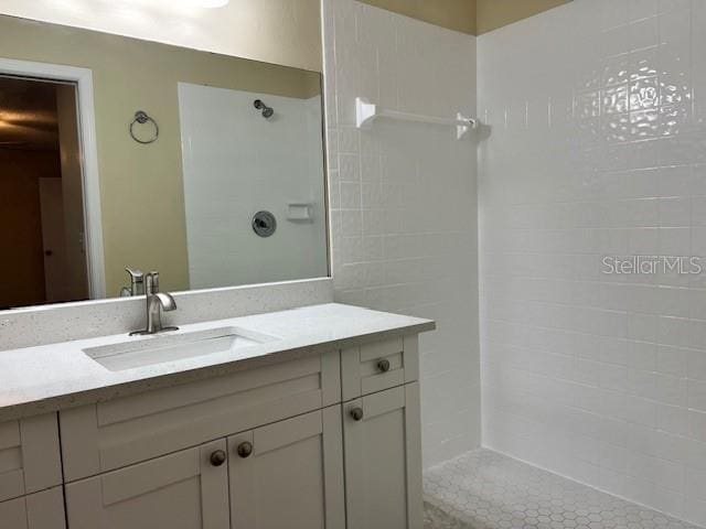 full bath featuring walk in shower and vanity