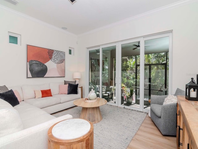 living area featuring light wood-type flooring and ornamental molding