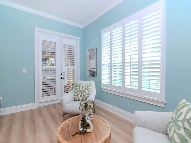 sitting room with wood finished floors, baseboards, and ornamental molding