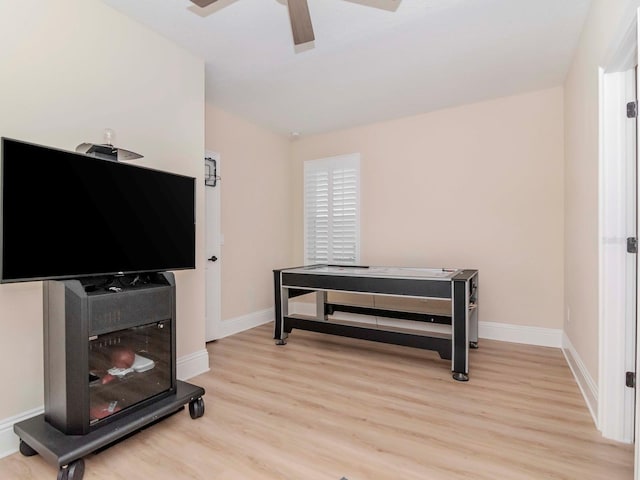 interior space featuring baseboards, light wood-type flooring, and ceiling fan