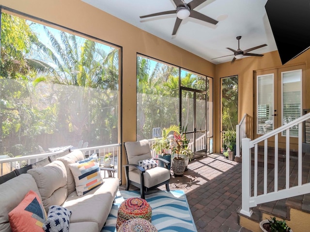 sunroom / solarium featuring ceiling fan