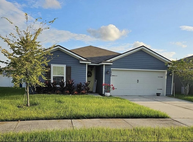 ranch-style house featuring a front yard, concrete driveway, and an attached garage