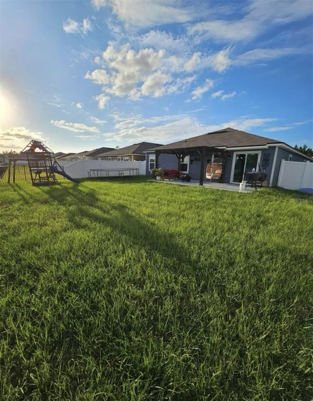 back of house featuring a gazebo, a yard, a patio, and fence