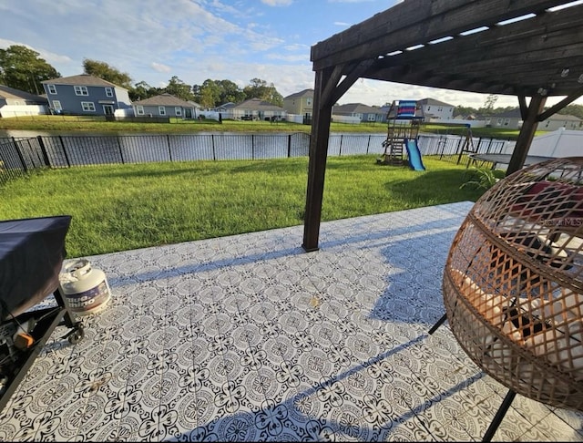 view of patio / terrace featuring a residential view, fence, a playground, and a water view