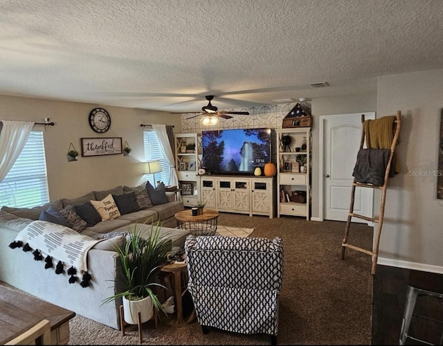 living area featuring visible vents, carpet floors, a healthy amount of sunlight, and ceiling fan