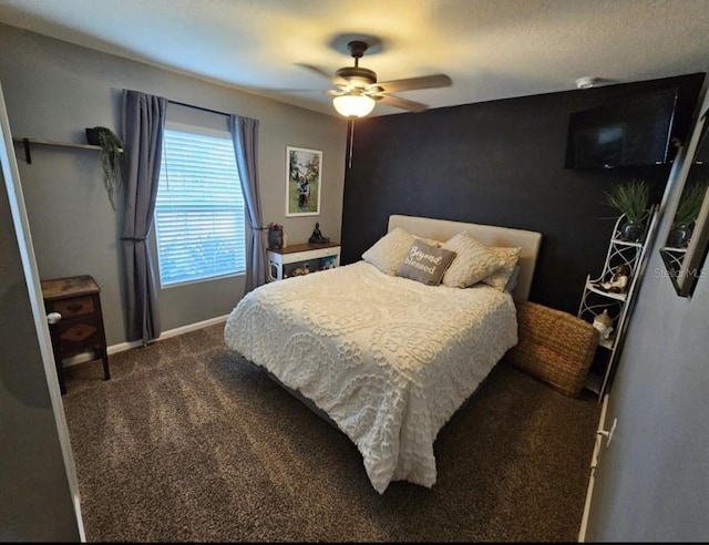 bedroom with dark colored carpet, baseboards, and a ceiling fan