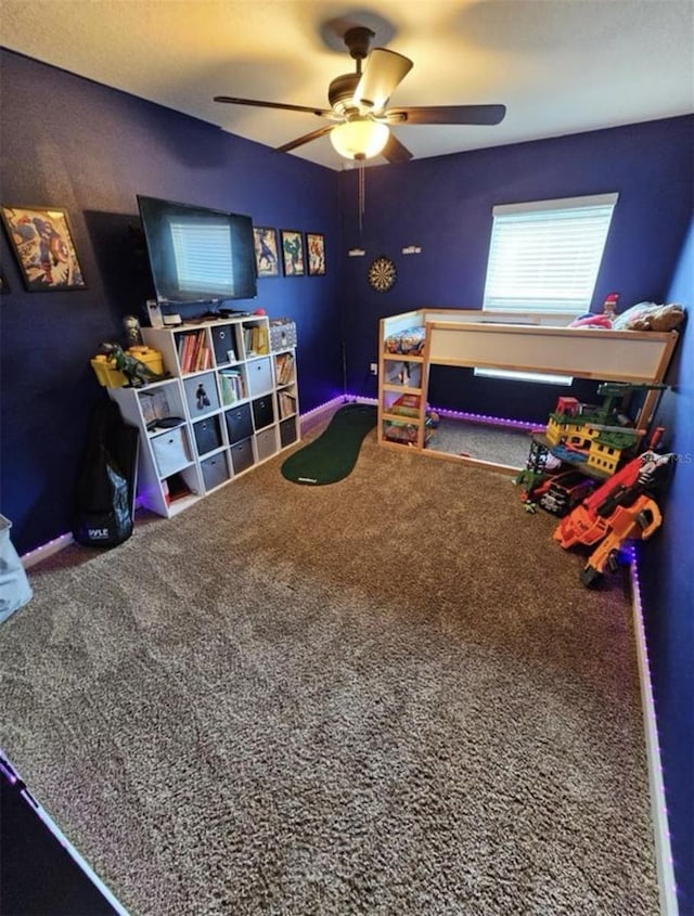 playroom with baseboards, carpet, and ceiling fan