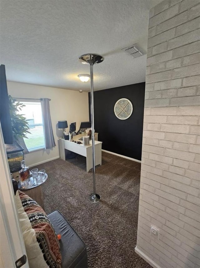 carpeted home office with visible vents, baseboards, and a textured ceiling